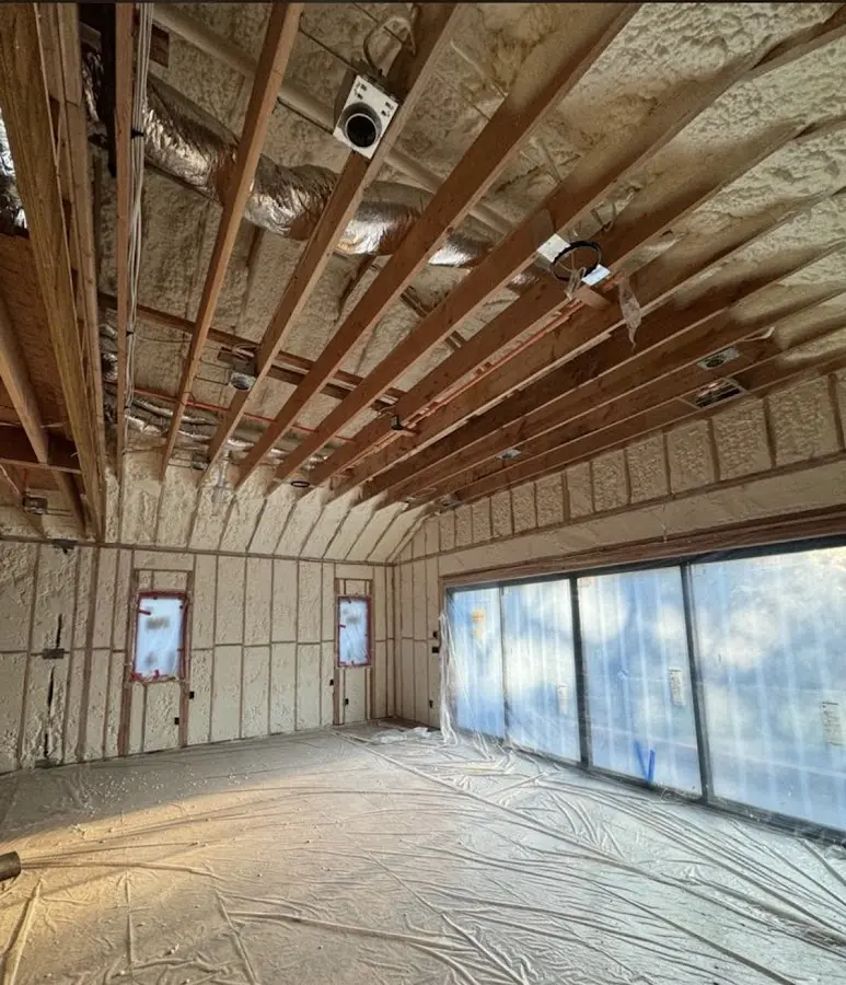 Interior walls and ceiling insulated with spray foam during new construction in East Manchester